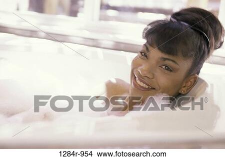 Picture - Portrait of a woman relaxing in a bathtub. Fotosearch