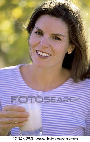 Portrait of a woman standing outdoors View Large Photo Image Stock Image - Portrait of a woman standing outdoors. Fotosearch