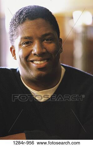 Stock Photograph - Portrait of a young man smiling. Fotosearch