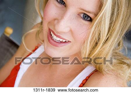 Portrait of a young woman smiling View Large Photo Image Stock Photo - Portrait of a young woman smiling. Fotosearch