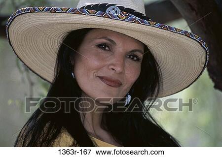 Portrait of a young woman wearing a hat smiling View Large Photo Image Stock Photo - Portrait of a young woman wearing a hat smiling. Fotosearch
