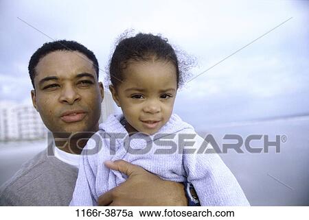 Stock Image - Portrait of father embracing his daughter. Fotosearch
