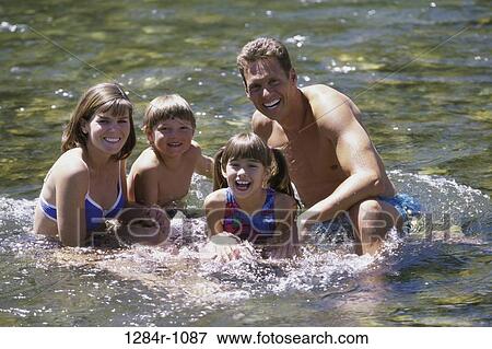 Portrait of parents and their children playing in water View Large Photo Image Stock Photo - Portrait of parents and their children playing in water. Fotosearch
