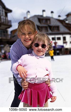 Stock Image - Portrait of two girls ice skating. Fotosearch