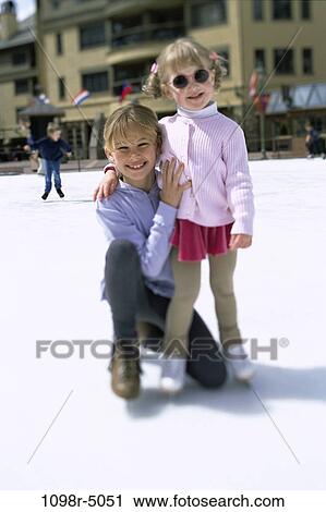 Stock Image - Portrait of two girls ice skating. Fotosearch