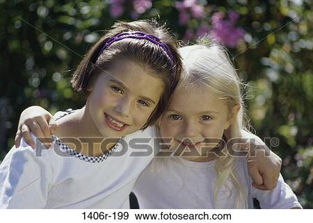 Portrait of two girls with arms around each other View Large Photo Image Stock Photo - Portrait of two girls with arms around each other. Fotosearch