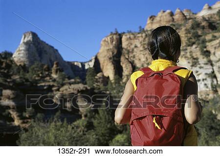Rear view of a girl with a backpack, Zion National Park, Utah, USA View Large Photo Image Stock Image - Rear view of a girl with a backpack, Zion National Park, Utah, USA. Fotosearch