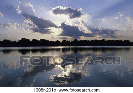 Stock Image - Reflections of clouds on a lake, Kansas, USA. Fotosearch