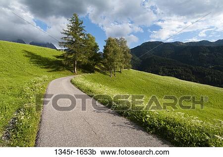 Stock Image - Road passing through a hill, Santa Maddalena, Funes Valley, Dolomites, Trentino-Alto-Adige, Italy. Fotosearch