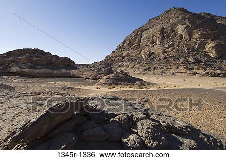 Rock formations in a desert, Tadrart Acacus, Fezzan, Libya View Large Photo Image Stock Photograph - Rock formations in a desert, Tadrart Acacus, Fezzan, Libya. Fotosearch