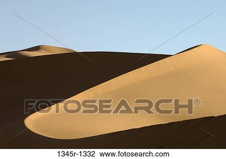 Stock Image - Sand dunes in a desert, Erg Awbari, Fezzan, Libya. Fotosearch