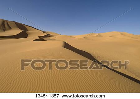 Sand dunes in a desert, Erg Awbari, Fezzan, Libya View Large Photo Image Stock Photo - Sand dunes in a desert, Erg Awbari, Fezzan, Libya. Fotosearch
