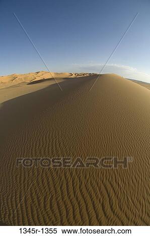Sand dunes in a desert, Erg Awbari, Fezzan, Libya View Large Photo Image Stock Photography - Sand dunes in a desert, Erg Awbari, Fezzan, Libya. Fotosearch