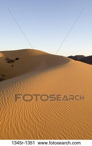 Sand dunes in a desert, Tadrart Acacus, Fezzan, Libya View Large Photo Image Stock Image - Sand dunes in a desert, Tadrart Acacus, Fezzan, Libya. Fotosearch