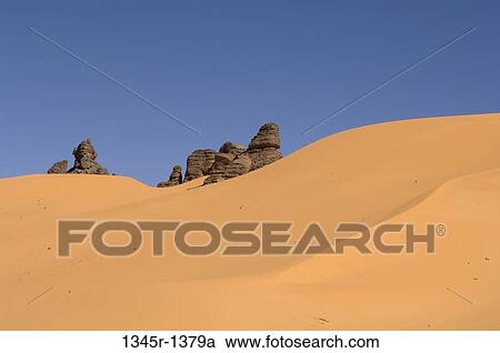 Sand dunes in a desert, Tadrart Acacus, Fezzan, Libya View Large Photo Image Stock Image - Sand dunes in a desert, Tadrart Acacus, Fezzan, Libya. Fotosearch