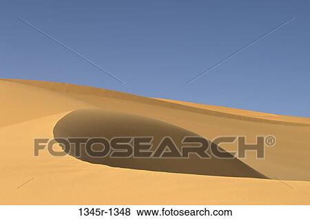 Sand dunes in a desert, Tadrart Acacus, Fezzan, Libya View Large Photo Image Stock Photo - Sand dunes in a desert, Tadrart Acacus, Fezzan, Libya. Fotosearch