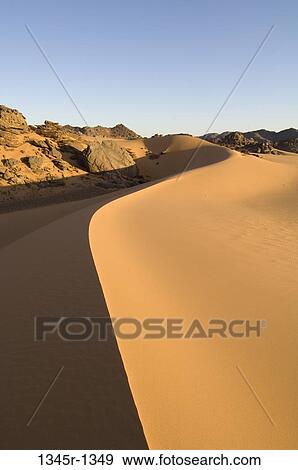Sand dunes in a desert, Tadrart Acacus, Fezzan, Libya View Large Photo Image Stock Photo - Sand dunes in a desert, Tadrart Acacus, Fezzan, Libya. Fotosearch