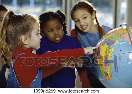 School children looking at a globe View Large Photo Image Stock Photo - School children looking at a globe. Fotosearch