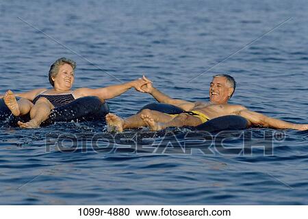 Senior couple floating on inner tubes View Large Photo Image Stock Image - Senior couple floating on inner tubes. Fotosearch