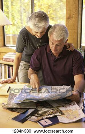 Senior couple looking at a map View Large Photo Image Stock Image - Senior couple looking at a map. Fotosearch