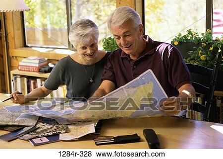 Senior couple looking at a map View Large Photo Image Stock Photo - Senior couple looking at a map. Fotosearch