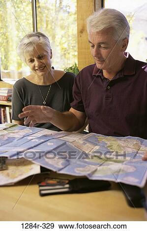 Senior couple looking at a map View Large Photo Image Stock Photo - Senior couple looking at a map. Fotosearch