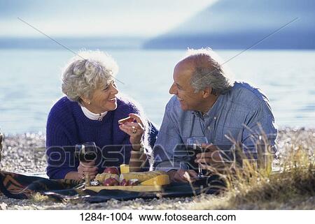 Picture - Senior couple lying down together. Fotosearch