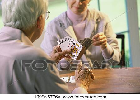 Stock Image - Senior couple playing cards. Fotosearch