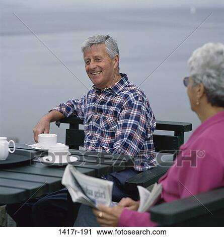 Senior couple sitting together outdoors View Large Photo Image Stock Image - Senior couple sitting together outdoors. Fotosearch
