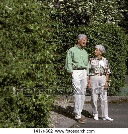 Stock Image - Senior couple standing together outdoors. Fotosearch