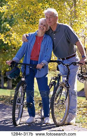 Stock Image - Senior couple with bicycles. Fotosearch