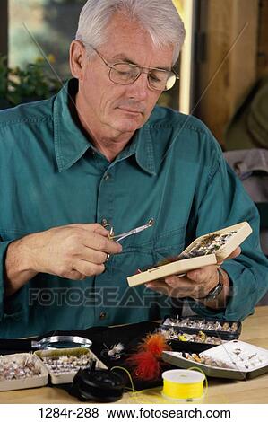 Senior man holding a fishing lure View Large Photo Image Stock Photo - Senior man holding a fishing lure. Fotosearch