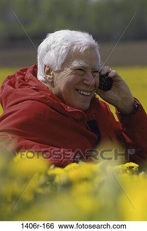 Senior man talking on a mobile phone View Large Photo Image Stock Photograph - Senior man talking on a mobile phone. Fotosearch