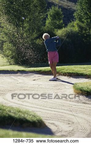 Stock Photography - Senior woman playing golf. Fotosearch