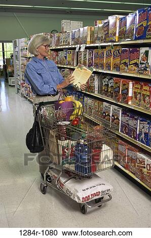 Senior woman shopping in a grocery store View Large Photo Image Stock Image - Senior woman shopping in a grocery store. Fotosearch