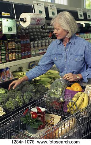 Senior woman shopping in a grocery store View Large Photo Image Stock Photo - Senior woman shopping in a grocery store. Fotosearch