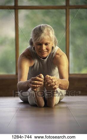 Senior woman stretching on the floor View Large Photo Image Picture - Senior woman stretching on the floor. Fotosearch