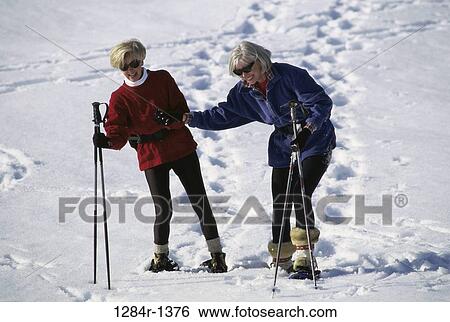 Stock Photograph - Senior women snowshoeing. Fotosearch