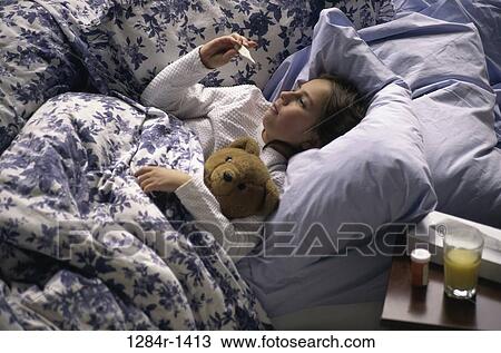 Stock Image - Sick girl lying in bed. Fotosearch