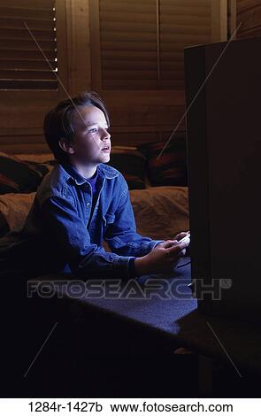 Side profile of a boy operating a game joystick View Large Photo Image Stock Image - Side profile of a boy operating a game joystick. Fotosearch