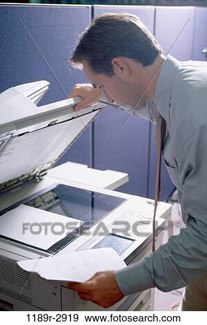 Side profile of a businessman using a photocopier machine View Large Photo Image Stock Photo - Side profile of a businessman using a photocopier machine. Fotosearch