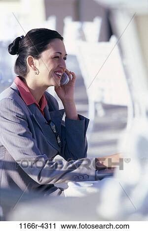 Side profile of a businesswoman talking on a mobile phone View Large Photo Image Stock Image - Side profile of a businesswoman talking on a mobile phone. Fotosearch