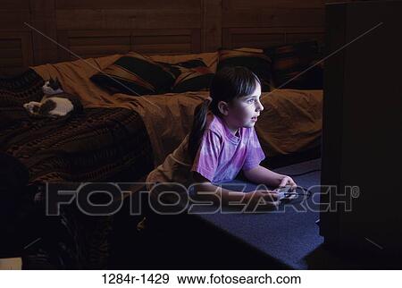 Side profile of a girl operating a game joystick View Large Photo Image Stock Photo - Side profile of a girl operating a game joystick. Fotosearch