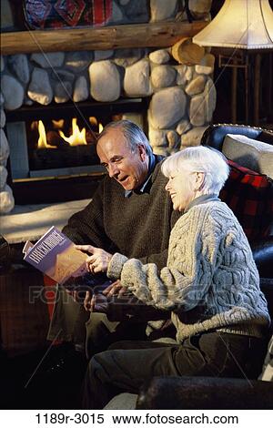 Side profile of a senior couple reading a magazine View Large Photo Image Stock Photography - Side profile of a senior couple reading a magazine. Fotosearch