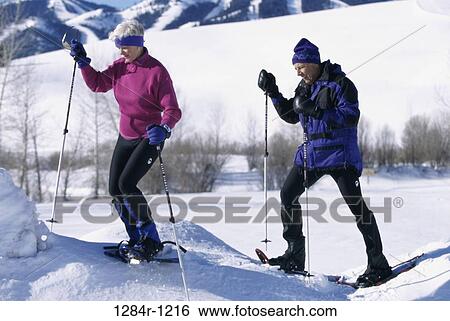 Side profile of a senior couple ice-skiing View Large Photo Image Stock Photograph - Side profile of a senior couple ice-skiing. Fotosearch