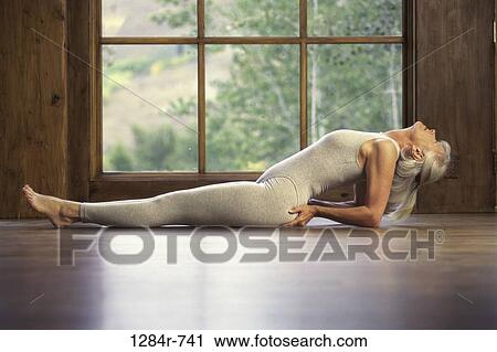 Side profile of a senior woman exercising on the floor View Large Photo Image Stock Image - Side profile of a senior woman exercising on the floor. Fotosearch