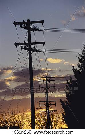 Silhouette of electricity pylons View Large Photo Image Stock Image - Silhouette of electricity pylons. Fotosearch