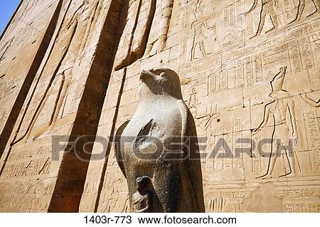 Stock Image - Statue of Horus at the First Pylon at the ruins of Edfu, Egypt. Fotosearch