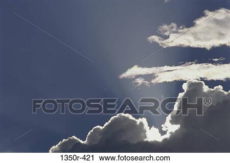 Sun rays shining behind clouds View Large Photo Image Stock Image - Sun rays shining behind clouds. Fotosearch