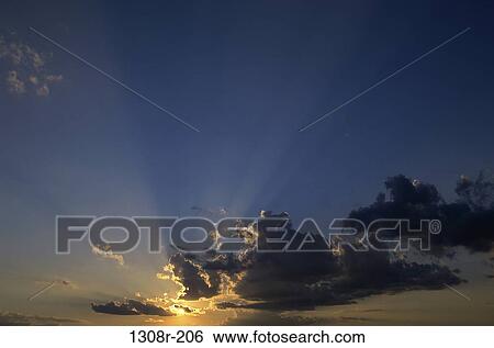 Sunlight shining through dark clouds View Large Photo Image Stock Photograph - Sunlight shining through dark clouds. Fotosearch